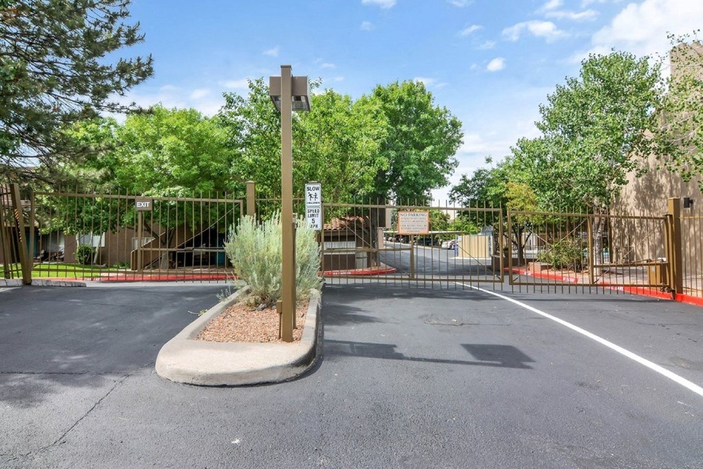 A parking lot with a sign and a gate.